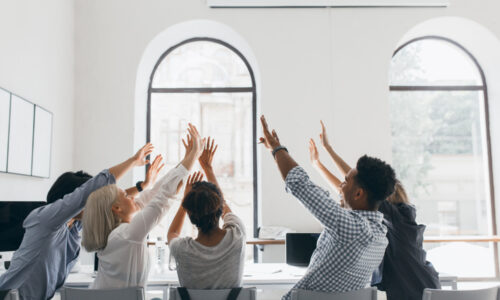 portrait-from-back-tired-students-stretching-after-long-work-indoor-photo-office-workers-fooling-around-during-meeting-conference-hall-with-big-windows